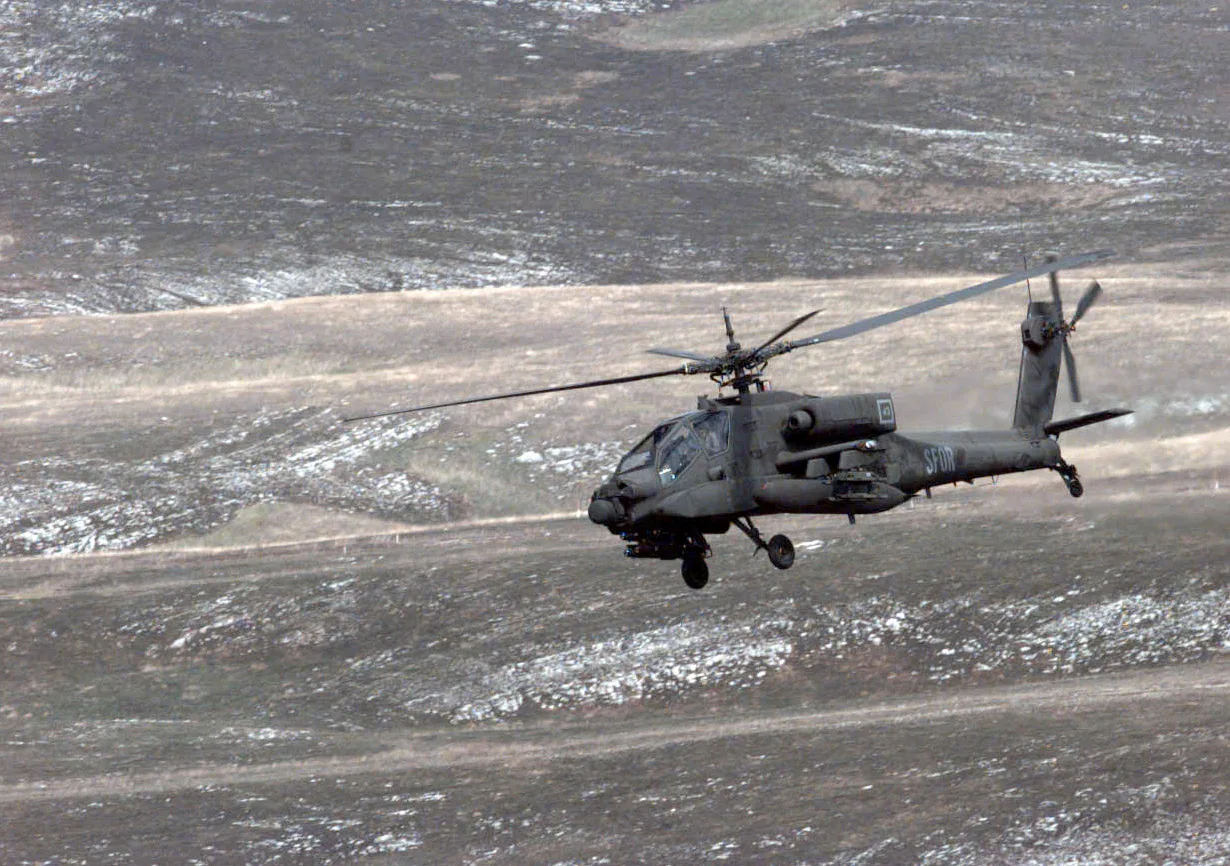 An AH-64 Apache flies to its firing position at the Glamoc Firing Range, Bosnia and Herzegovina, on Sept. 2, 1998. Helicopters from the U.S. Army's 6th Squadron, 6th U.S. Cavalry, 11th Aviation Regiment are conducting a live fire exercise u